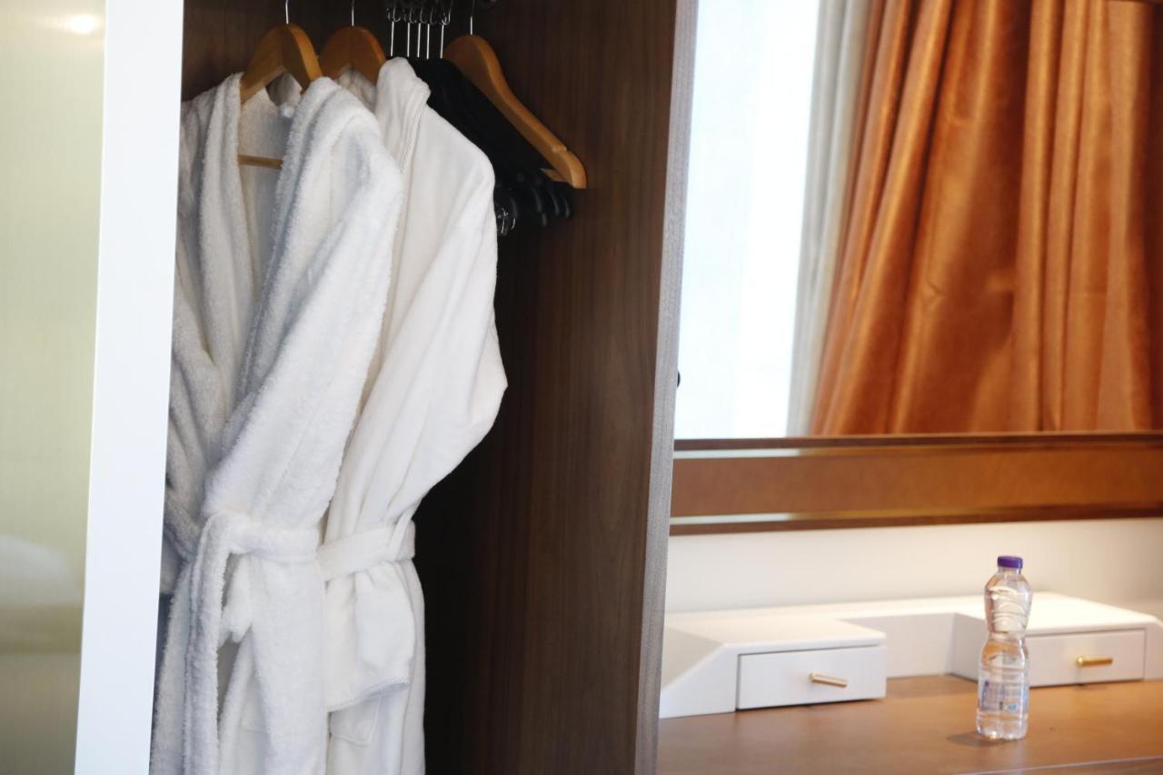 Waterfront Hotel Apartment Lusail Экстерьер фото A bathrobe hanging in a closet